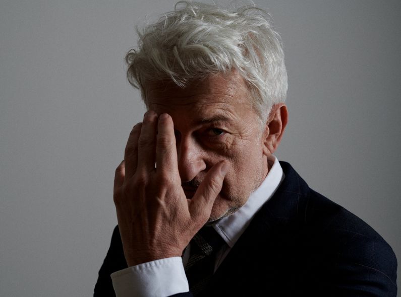 DARIUS RAMAZANI with a portrait of German actor and screenwriter DOMINIC RAACKE